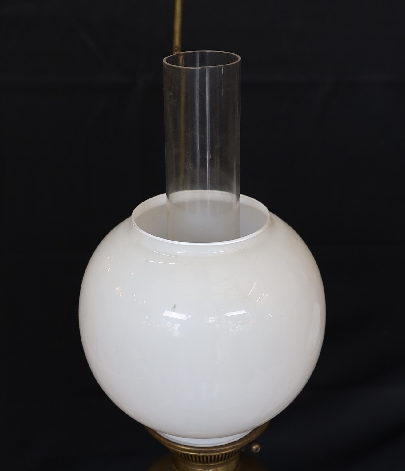 A Victorian Hinks brass counterbalanced hanging oil lamp with opaque glass shade and fluted balance weight, height 140cm, width 55cm